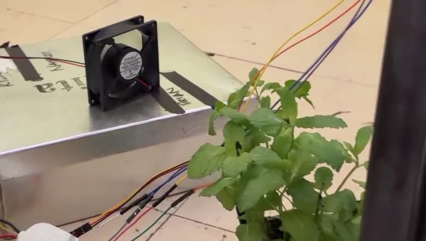 Bonita controller box with cooling fan beside a plant