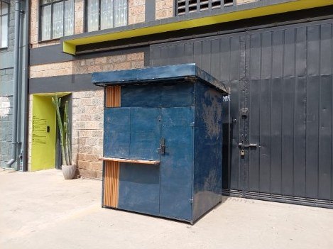 Struktuk smart kiosk in blue steel with timber panels and a serving counter